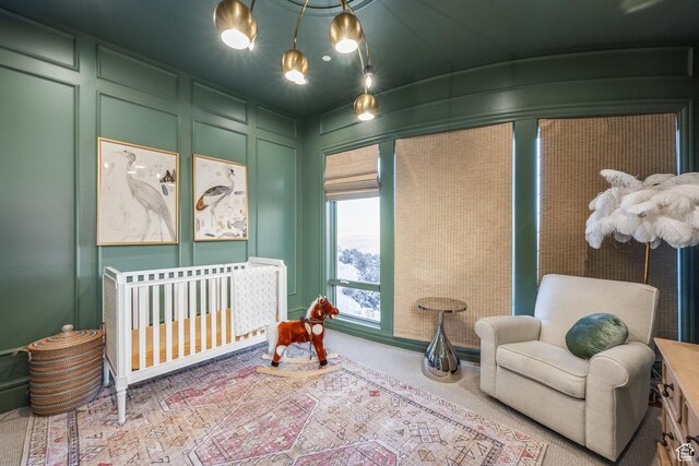 1515 E Bluff Point Dr, Draper, UT 84020 - bedroom featuring a crib, a decorative wall, and carpet flooring