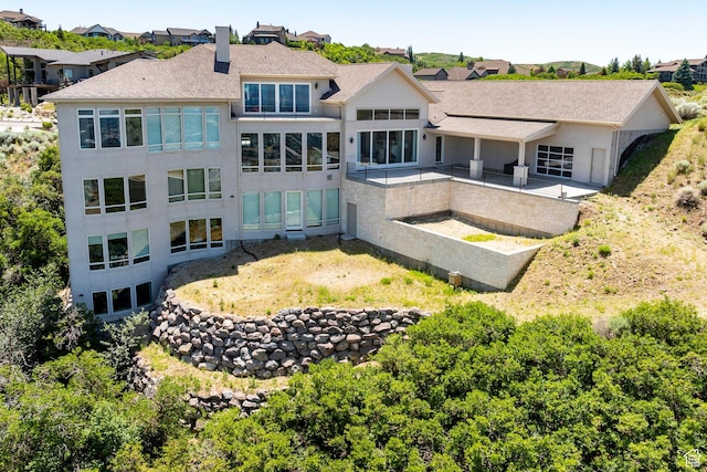 1515 E Bluff Point Dr, Draper, UT 84020 - back of house featuring a chimney, a shingled roof, and a residential view