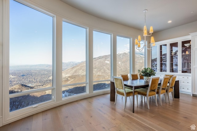 1515 E Bluff Point Dr, Draper, UT 84020 - dining room featuring a mountain view, an inviting chandelier, and light hardwood / wood-style flooring
