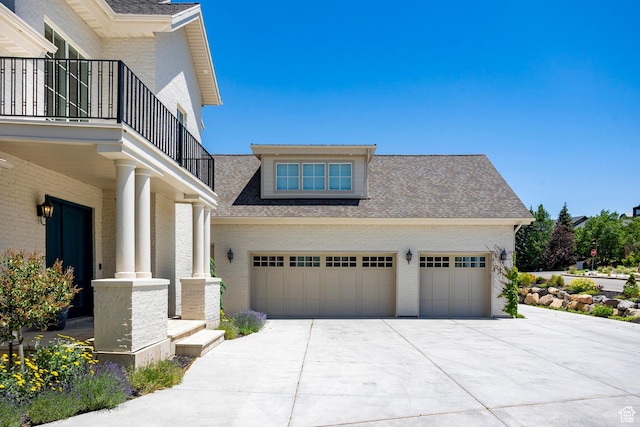 1515 E Bluff Point Dr, Draper, UT 84020 - view of property exterior featuring concrete driveway, a balcony, brick siding, and roof with shingles