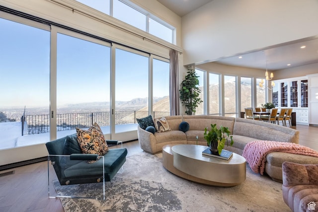 1515 E Bluff Point Dr, Draper, UT 84020 - sunroom featuring a notable chandelier, a mountain view, and a wealth of natural light