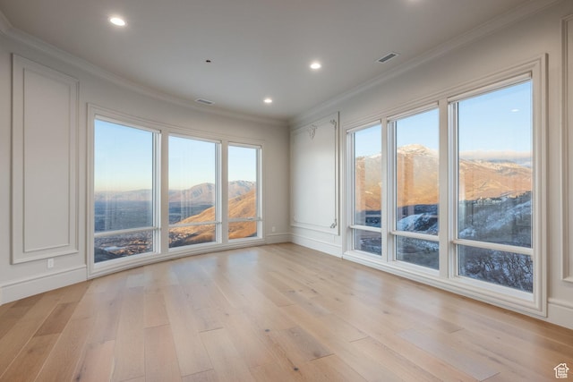 1515 E Bluff Point Dr, Draper, UT 84020 - empty room with a mountain view, light hardwood / wood-style floors, and ornamental molding