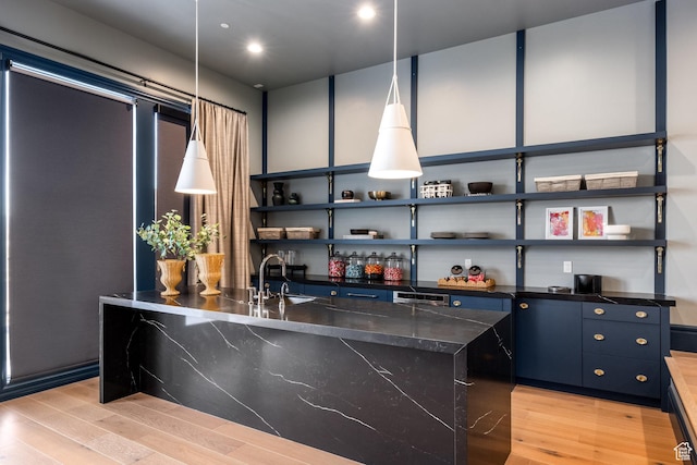 1515 E Bluff Point Dr, Draper, UT 84020 - kitchen with pendant lighting, sink, light hardwood / wood-style flooring, blue cabinetry, and a kitchen island
