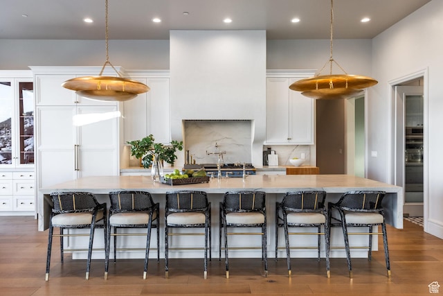 1515 E Bluff Point Dr, Draper, UT 84020 - kitchen featuring white cabinets, a kitchen breakfast bar, and a large island