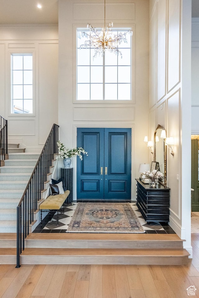 1515 E Bluff Point Dr, Draper, UT 84020 - foyer with a towering ceiling, stairway, wood-type flooring, and a chandelier