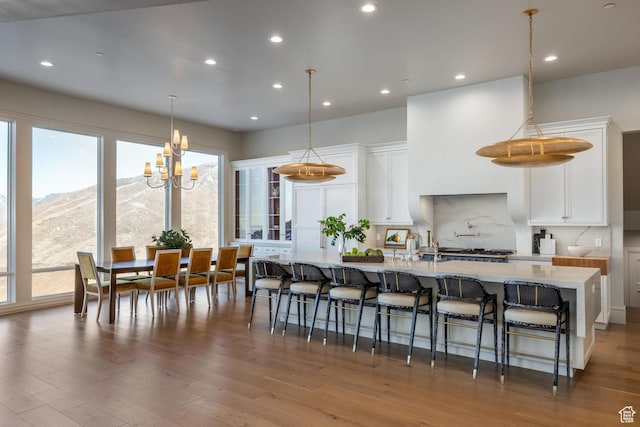 1515 E Bluff Point Dr, Draper, UT 84020 - kitchen with a mountain view, pendant lighting, white cabinetry, and hardwood / wood-style floors