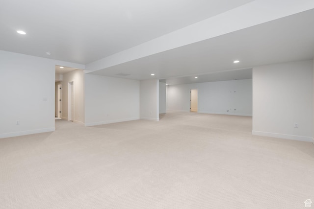 basement featuring light carpet