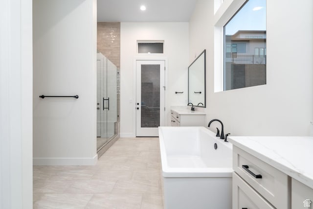 bathroom with vanity and independent shower and bath