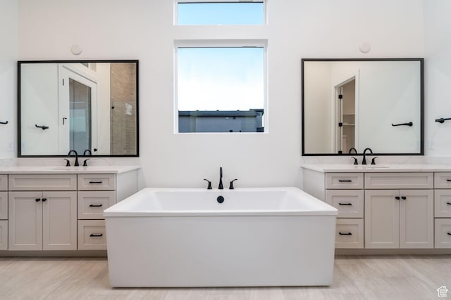 bathroom featuring vanity and a tub to relax in