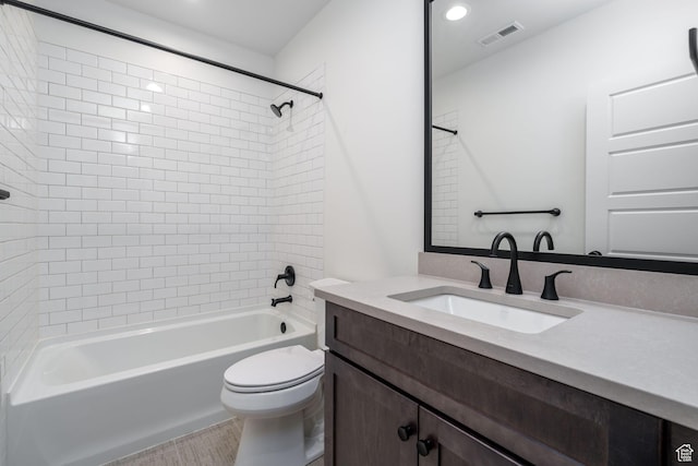full bathroom with vanity, toilet, and tiled shower / bath