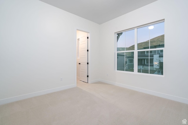 empty room featuring light carpet
