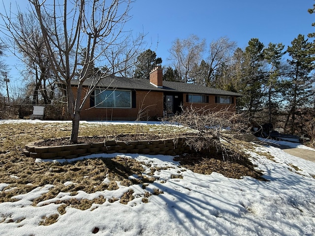 exterior space featuring brick siding and a chimney