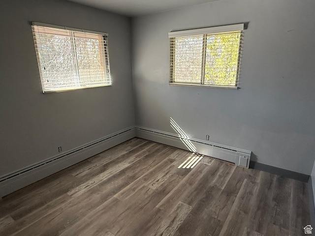 unfurnished room featuring baseboards and wood finished floors