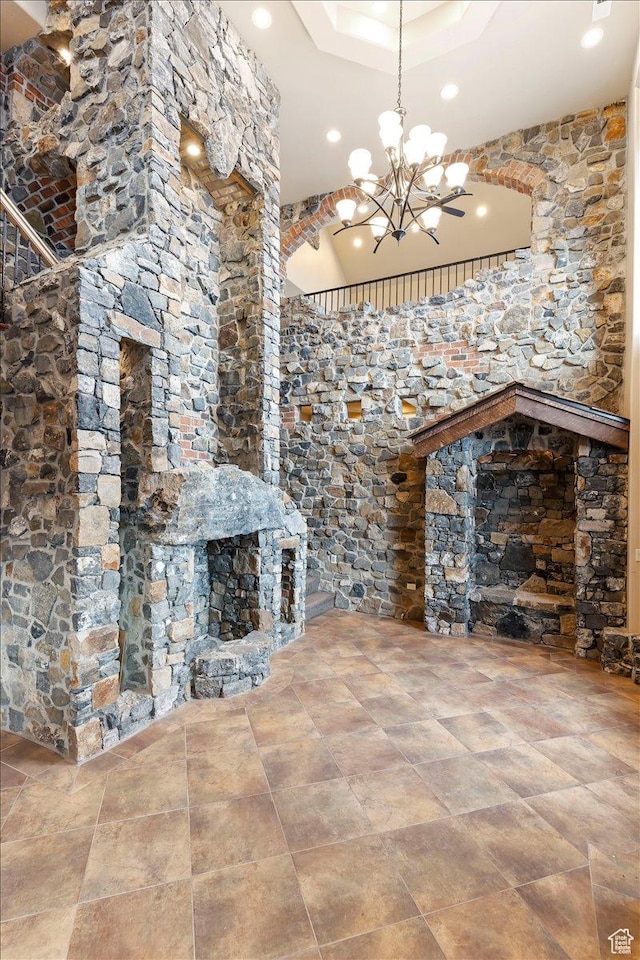 246 E Woods Creek Dr, Morgan, UT 84050 - unfurnished living room with a stone fireplace and an inviting chandelier