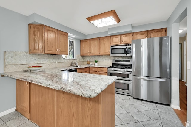 967 E 2800 N, North Ogden, UT 84414 - kitchen featuring tasteful backsplash, light tile patterned floors, stainless steel appliances, light stone counters, and a peninsula