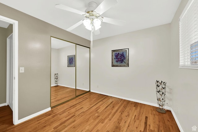 967 E 2800 N, North Ogden, UT 84414 - unfurnished bedroom featuring baseboards, a closet, ceiling fan, and wood finished floors
