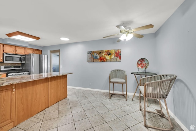 967 E 2800 N, North Ogden, UT 84414 - kitchen with light tile patterned flooring, appliances with stainless steel finishes, and baseboards