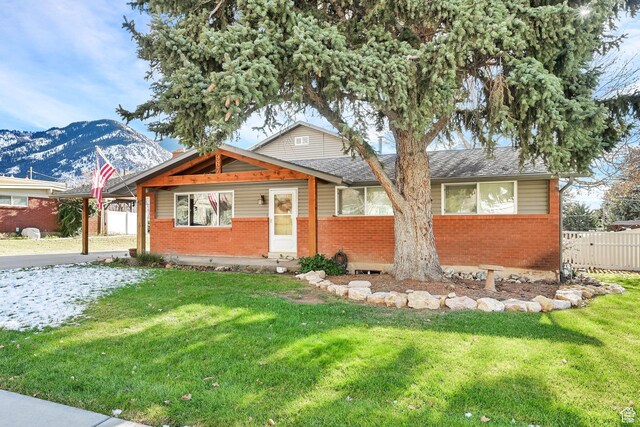 967 E 2800 N, North Ogden, UT 84414 - view of front of property featuring brick siding, fence, and a front lawn