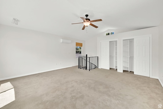 967 E 2800 N, North Ogden, UT 84414 - unfurnished bedroom featuring multiple closets, a wall mounted AC, vaulted ceiling, carpet flooring, and a ceiling fan
