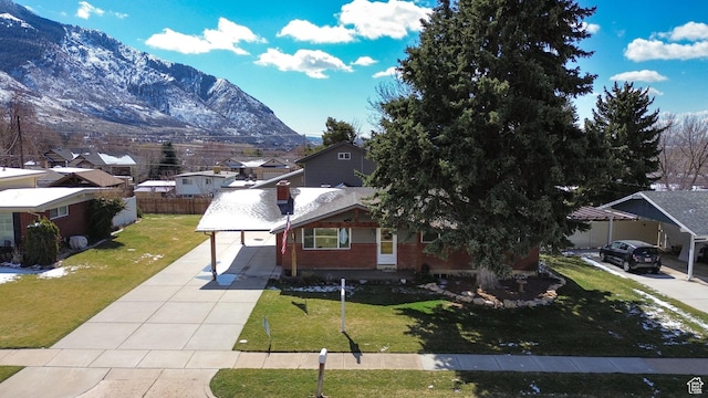 967 E 2800 N, North Ogden, UT 84414 - view of front of house with driveway, a front yard, fence, brick siding, and a mountain view