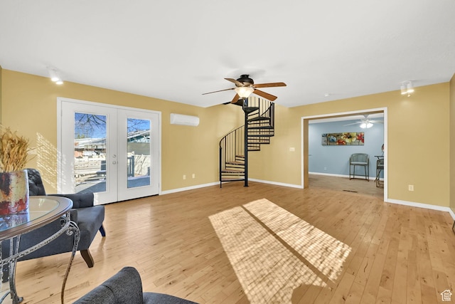 967 E 2800 N, North Ogden, UT 84414 - living room with a wall unit AC, stairs, french doors, light wood finished floors, and a ceiling fan