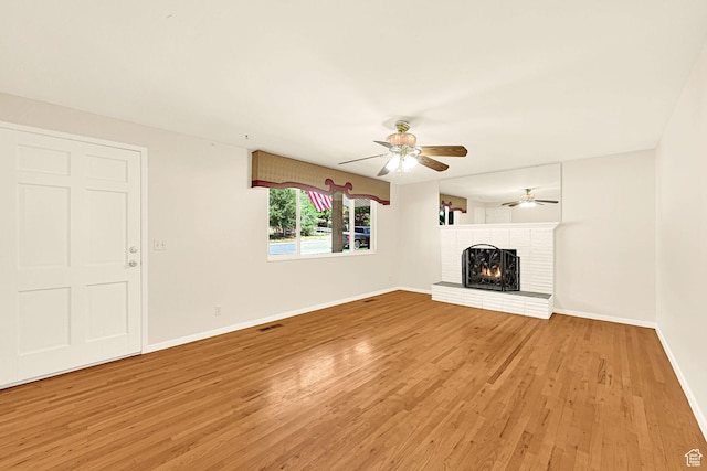 967 E 2800 N, North Ogden, UT 84414 - unfurnished living room featuring light wood-style flooring, a fireplace, a ceiling fan, and baseboards