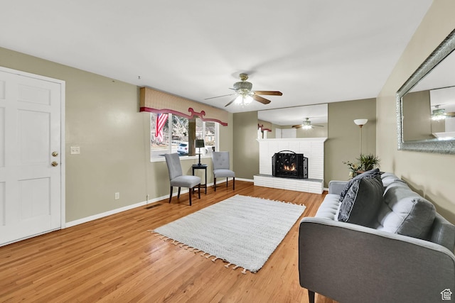 967 E 2800 N, North Ogden, UT 84414 - living room featuring visible vents, a brick fireplace, baseboards, a ceiling fan, and light wood-style floors