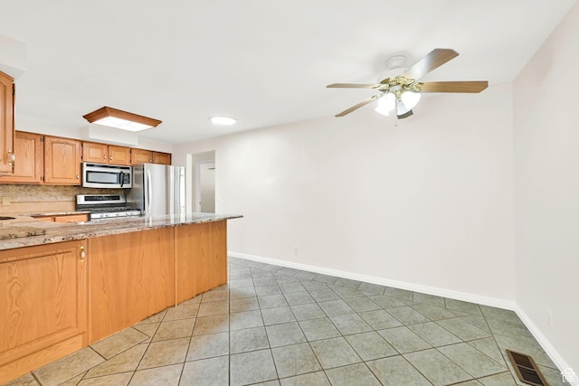 967 E 2800 N, North Ogden, UT 84414 - kitchen with appliances with stainless steel finishes, light tile patterned flooring, a peninsula, baseboards, and recessed lighting