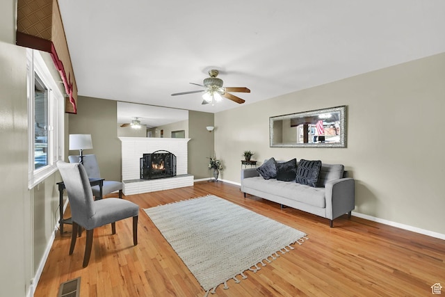 967 E 2800 N, North Ogden, UT 84414 - living area with visible vents, a brick fireplace, baseboards, wood finished floors, and a ceiling fan