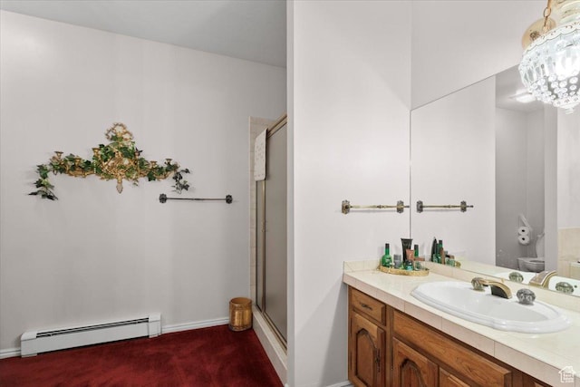 bathroom featuring toilet, an enclosed shower, baseboard heating, and vanity