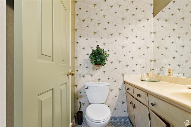 bathroom with tile patterned floors, vanity, and toilet
