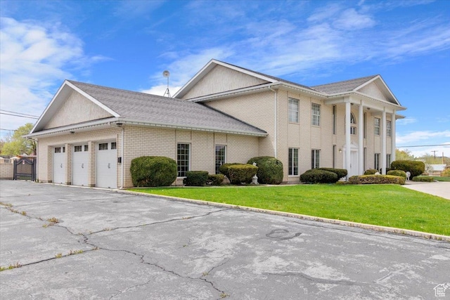 view of front of home with a garage and a front lawn