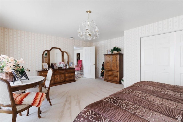 carpeted bedroom featuring an inviting chandelier and a closet