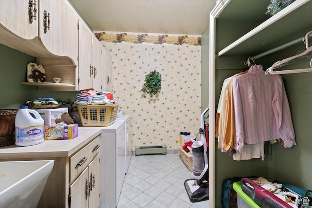 clothes washing area with sink, cabinets, a baseboard radiator, independent washer and dryer, and light tile patterned floors