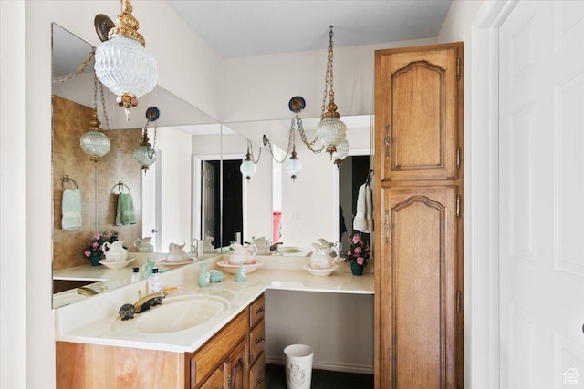 bathroom with vanity and an inviting chandelier