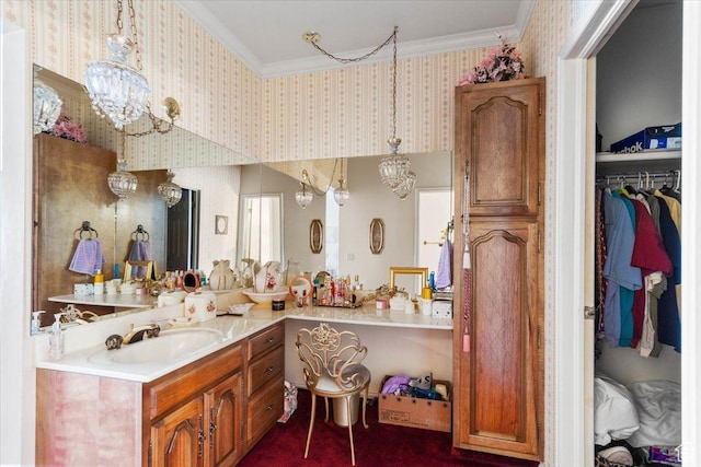 bathroom with vanity, an inviting chandelier, and crown molding