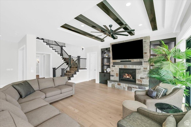 4009 S 2420 E, St George, UT 84790 - living area with light wood-style flooring, a stone fireplace, stairs, beamed ceiling, and recessed lighting