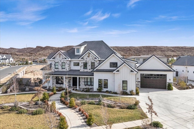 4009 S 2420 E, St George, UT 84790 - view of front facade with stone siding, driveway, a mountain view, a porch, and board and batten siding