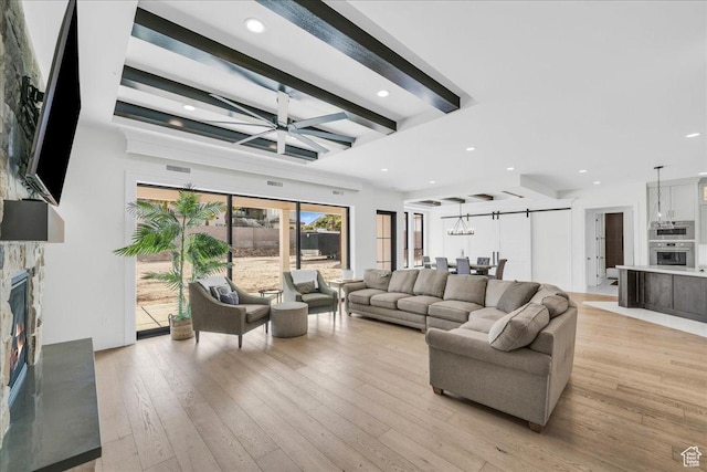 4009 S 2420 E, St George, UT 84790 - living room with a stone fireplace, light wood-type flooring, beamed ceiling, a ceiling fan, and recessed lighting