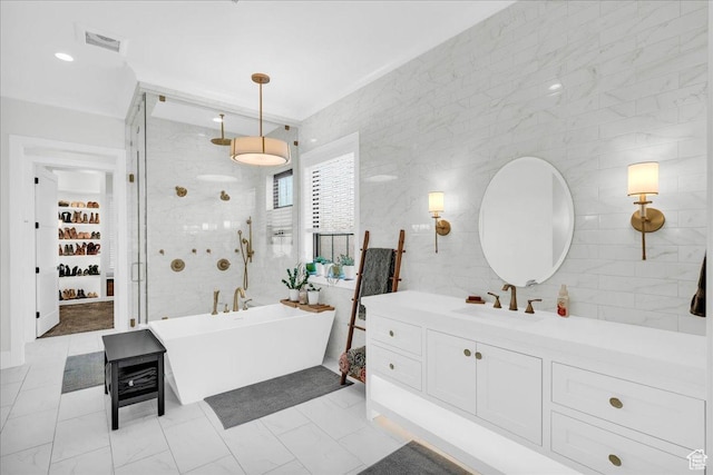 4009 S 2420 E, St George, UT 84790 - bathroom featuring a freestanding tub, vanity, walk in shower, and tile walls