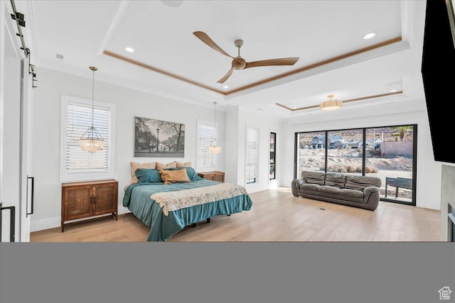 4009 S 2420 E, St George, UT 84790 - bedroom featuring a raised ceiling, light wood finished floors, a barn door, recessed lighting, and multiple windows