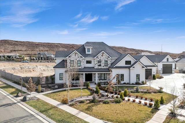 4009 S 2420 E, St George, UT 84790 - view of front of house with a porch, driveway, a mountain view, and a front lawn