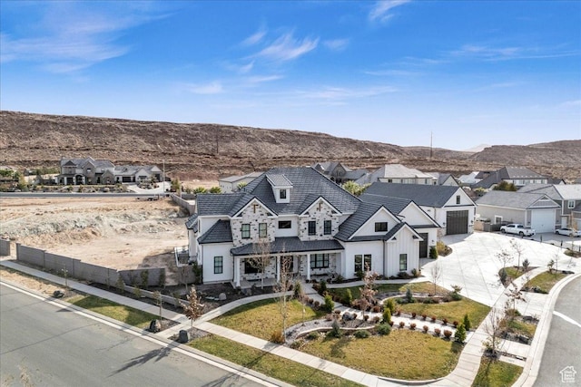 4009 S 2420 E, St George, UT 84790 - view of front facade with concrete driveway, a mountain view, a residential view, covered porch, and board and batten siding