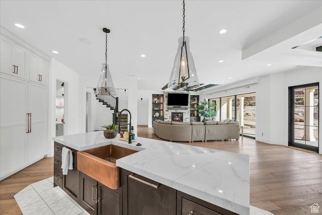 4009 S 2420 E, St George, UT 84790 - kitchen with open floor plan, light wood-style flooring, an island with sink, pendant lighting, and recessed lighting