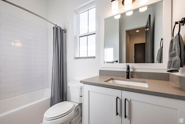 full bathroom with shower / tub combo with curtain, vanity, and toilet