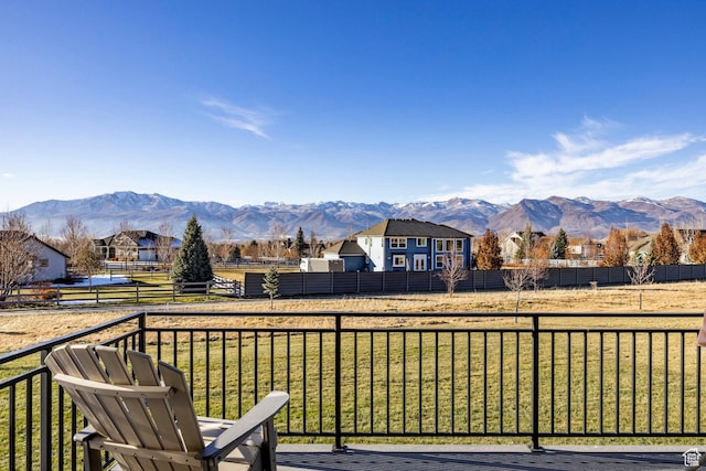 wooden deck with a lawn and a mountain view