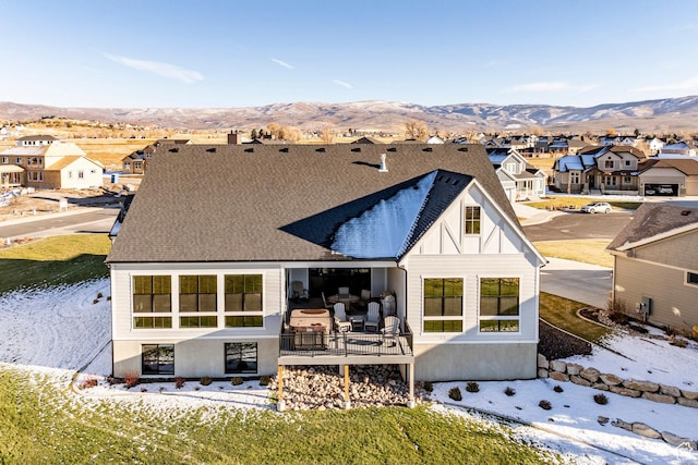rear view of property featuring a mountain view