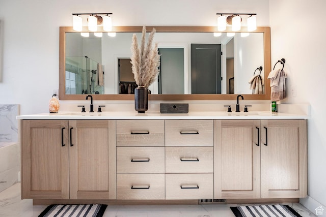 bathroom with vanity and a shower with shower door