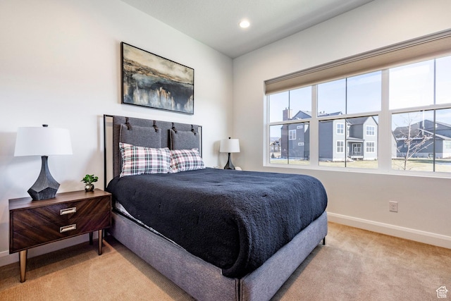 carpeted bedroom featuring multiple windows