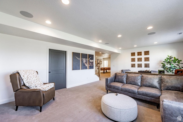 living room featuring carpet flooring and a textured ceiling